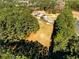 An aerial view highlights the wooded lot with a mobile home at 1515 Ozora Rd, Loganville, GA 30052
