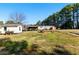 View of the backyard with sheds, mature trees, and a mobile home at 1515 Ozora Rd, Loganville, GA 30052