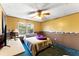Comfortable bedroom with a window view and plush blue carpet, creating a serene retreat at 1515 Ozora Rd, Loganville, GA 30052