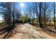 A long dirt driveway leads toward a mobile home surrounded by trees at 1515 Ozora Rd, Loganville, GA 30052
