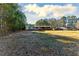 Spacious front yard featuring a mobile home with a covered porch, surrounded by trees at 1515 Ozora Rd, Loganville, GA 30052