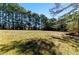 Scenic view of a grassy lawn surrounded by mature trees, offering privacy and a natural setting at 1515 Ozora Rd, Loganville, GA 30052
