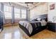 Bedroom with exposed brick wall, large window, and modern decor at 244 Peters St # 23, Atlanta, GA 30313