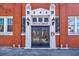 The entrance to the building featuring a black door, sidelights, and transom at 244 Peters St # 23, Atlanta, GA 30313