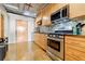 Modern kitchen with stainless steel appliances, light wood cabinets, and designer backsplash at 244 Peters St # 23, Atlanta, GA 30313