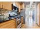 Modern kitchen featuring stainless steel appliances, granite countertops, and attractive backsplash at 244 Peters St # 23, Atlanta, GA 30313
