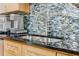 Kitchen sink with light wood cabinetry, stainless steel appliances, and designer backsplash at 244 Peters St # 23, Atlanta, GA 30313