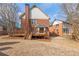 A back view of the home shows a wooden deck with brick and siding exterior at 2976 Wilsons Crossing Ct, Decatur, GA 30033