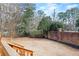 Spacious backyard featuring a brick wall, mature trees, and a well-maintained lawn at 2976 Wilsons Crossing Ct, Decatur, GA 30033
