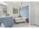 Relaxing bathroom boasting a clawfoot tub, blue vanity, and marble floors at 2976 Wilsons Crossing Ct, Decatur, GA 30033
