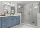 Modern bathroom showcasing a glass shower, blue vanity, and stylish tile work at 2976 Wilsons Crossing Ct, Decatur, GA 30033