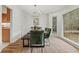 Elegant dining room with chandelier, green velvet chairs, wood floors and trim at 2976 Wilsons Crossing Ct, Decatur, GA 30033