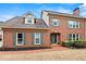 Charming two-story brick home featuring green shutters, brick walkway, and well-manicured landscaping at 2976 Wilsons Crossing Ct, Decatur, GA 30033