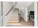 Bright foyer with hardwood floors, staircase with wood railing, and paneled walls at 2976 Wilsons Crossing Ct, Decatur, GA 30033
