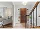 Inviting foyer with hardwood floors, staircase, wooden front door, and stylish decor at 2976 Wilsons Crossing Ct, Decatur, GA 30033