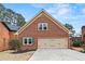 Attached two-car garage featuring brick facade, gabled roof, and driveway at 2976 Wilsons Crossing Ct, Decatur, GA 30033