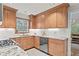 Bright eat-in kitchen featuring light wood cabinetry, granite counters, stainless appliances and tile flooring at 2976 Wilsons Crossing Ct, Decatur, GA 30033