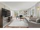 Bright living room with fireplace, built-in shelving, neutral decor, and hardwood floors at 2976 Wilsons Crossing Ct, Decatur, GA 30033