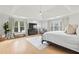 Spacious main bedroom with a tray ceiling, large windows, hardwood floors, and a sitting area, perfect for relaxation at 2976 Wilsons Crossing Ct, Decatur, GA 30033