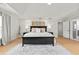Expansive main bedroom featuring tray ceilings, hardwood floors, and a decorative rug at 2976 Wilsons Crossing Ct, Decatur, GA 30033