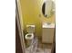 Small full bath features vinyl floors, an oval mirror, and a white vanity with storage at 650 Robert E Lee Pkwy, Jonesboro, GA 30238