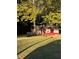 Charming one-story red home with green grass and mature trees in a peaceful setting at 650 Robert E Lee Pkwy, Jonesboro, GA 30238