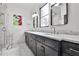 Stylish bathroom featuring double sinks, marble countertops, sleek dark cabinets, and modern fixtures at 1100 Arkwright Se Pl # B, Atlanta, GA 30316