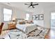Bright bedroom featuring a ceiling fan, large windows, hardwood floors, and a stylish rug at 1100 Arkwright Se Pl # B, Atlanta, GA 30316