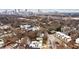 Urban aerial shot highlighting the cityscape beyond charming homes nestled among trees at 1100 Arkwright Se Pl # B, Atlanta, GA 30316