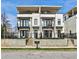 Modern townhome with white brick, black trim, balconies, and a small front yard at 1100 Arkwright Se Pl # B, Atlanta, GA 30316