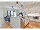 Bright, open-concept kitchen with white cabinets, island seating, and modern appliances at 1100 Arkwright Se Pl # B, Atlanta, GA 30316