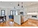 Open-concept kitchen with island seating, stainless steel appliances, and living room view at 1100 Arkwright Se Pl # B, Atlanta, GA 30316