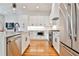 Modern kitchen with white cabinets, stainless steel appliances, and hardwood floors at 1100 Arkwright Se Pl # B, Atlanta, GA 30316