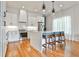 Modern kitchen with white cabinets, quartz countertops, pendant lighting, and hardwood floors at 1100 Arkwright Se Pl # B, Atlanta, GA 30316
