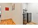Convenient laundry room with modern washer and dryer, storage cabinets, and hardwood floors at 1100 Arkwright Se Pl # B, Atlanta, GA 30316