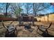 Cozy backyard featuring a fire pit and Adirondack chairs on a pebble bed, surrounded by a wooden fence at 1475 Elizabeth Ln, Atlanta, GA 30344