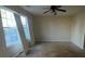 Bright living room with large windows, ceiling fan, and neutral walls at 304 Klinetop Dr, Mcdonough, GA 30253