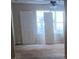 Bright living room with large windows, ceiling fan, and neutral walls at 304 Klinetop Dr, Mcdonough, GA 30253