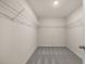 A spacious walk-in closet features built-in wire shelving and neutral carpeting at 44 Leggett Dr # 179, Villa Rica, GA 30180