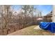 Backyard featuring a wood fence, trees, and a covered motorcycle at 5015 Rapahoe Trl, Atlanta, GA 30349