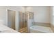 Modern bathroom featuring double sinks, shower, and tub with tile surround at 5015 Rapahoe Trl, Atlanta, GA 30349
