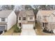 Two-story home featuring stone accents, neutral colors, and an attached two-car garage at 5015 Rapahoe Trl, Atlanta, GA 30349