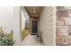 Home entryway featuring a covered porch with seating and stone veneer wall at 5015 Rapahoe Trl, Atlanta, GA 30349