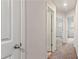 Bright hallway with neutral paint, carpet, and white doors leading to various rooms at 5015 Rapahoe Trl, Atlanta, GA 30349