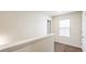 Hallway with neutral walls, white baseboards, door and window with blinds at 5015 Rapahoe Trl, Atlanta, GA 30349