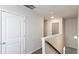 Hallway with neutral walls and carpet, white baseboards, and doors at 5015 Rapahoe Trl, Atlanta, GA 30349