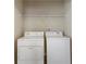 Laundry room with a white dryer and washing machine along with a shelf at 5015 Rapahoe Trl, Atlanta, GA 30349