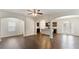Open floor plan with hardwood floors, arched doorways, and modern ceiling fan at 5015 Rapahoe Trl, Atlanta, GA 30349