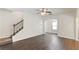 Living area featuring dark wood floors and carpeted staircase to the second level at 5015 Rapahoe Trl, Atlanta, GA 30349