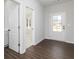 Inviting foyer with hardwood floors, white doors, and ample natural light coming through the glass panel door at 718 Ocmulgee Crossing, Locust Grove, GA 30248